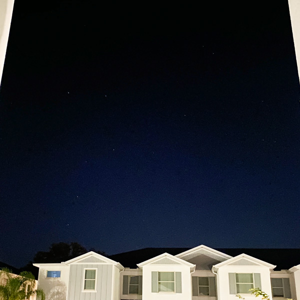 Photo of the morning sky looking over a row of townhomes