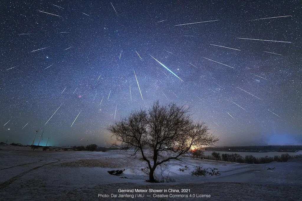 Shows Geminids meteor trails over a winter pastoral scene in China, 2021.