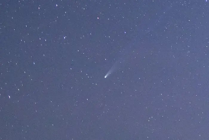 Shows Comet Lemmon in October 2025 closeup against a blue starry sky.