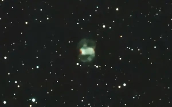 Messier 76 nebula in the middle, showing green tint and cropped view from a Seestar S50 telescope.