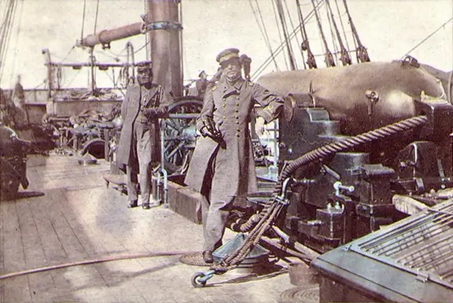Captain Raphael Semmes, CSS Alabama's commanding officer, standing by his ship's 110-pounder rifled gun during her visit to Capetown in August 1863. His executive officer, First Lieutenant John M. Kell, is in the background,